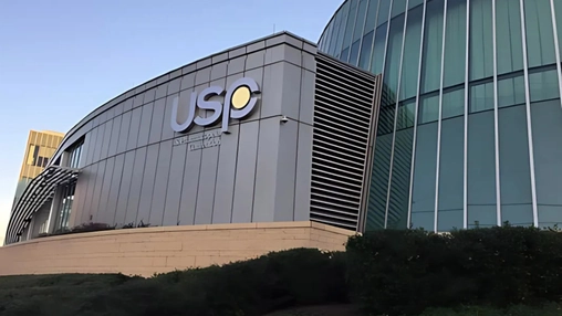 USP building symbolizing global drug purity standards reform