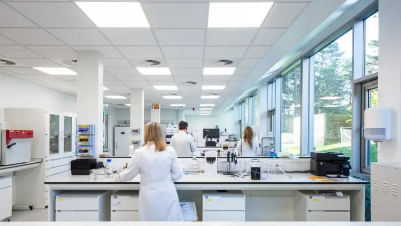 Modern drug research laboratory with researchers conducting experiments
